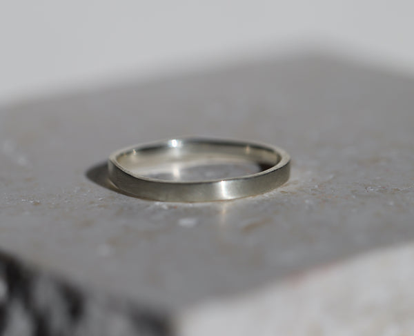 Silver ring on a textured gray surface