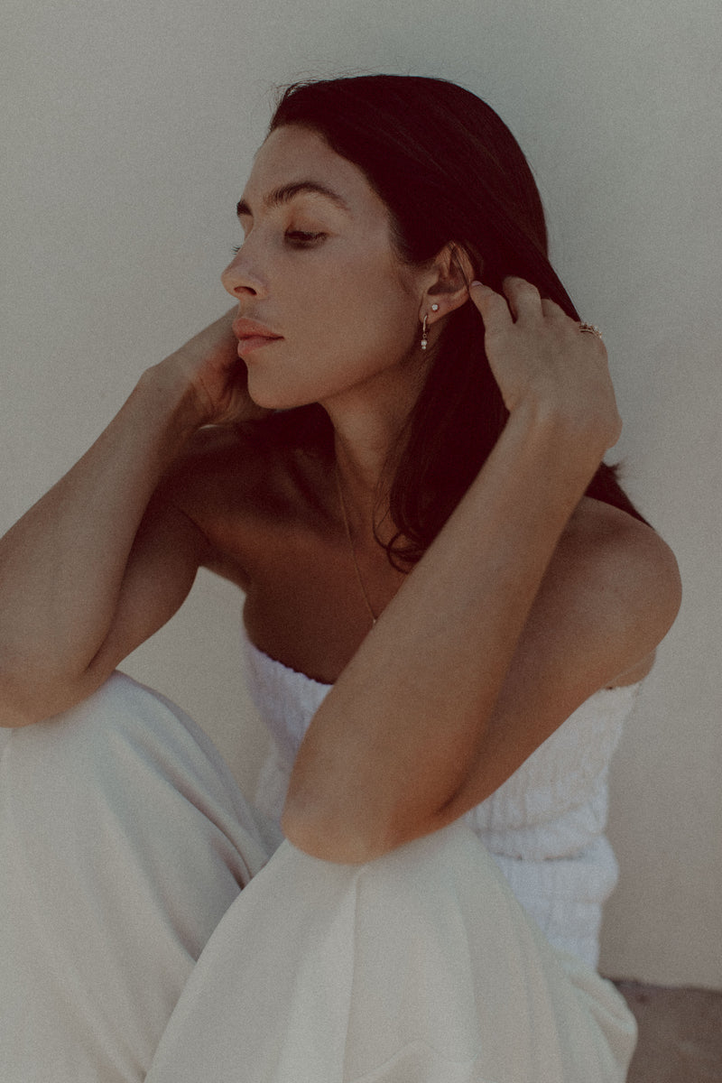 Model wears diamond Therese earrings in 9ct gold, Katie Rose Jewellery paired with diamond stud earring. 