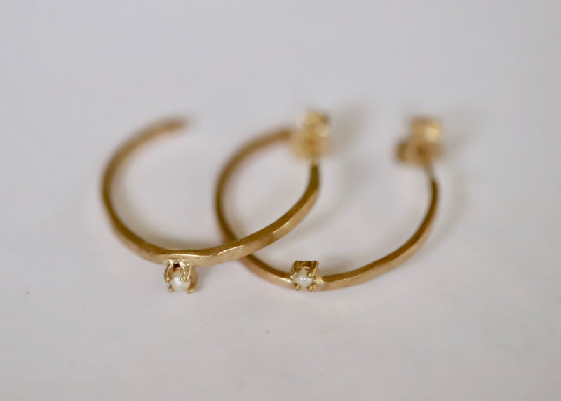 Manahau hoops in gold by Katie Rose Jewellery, organic edging featuring a 2mm round pearl claw set sitting half-way down the hoop. 